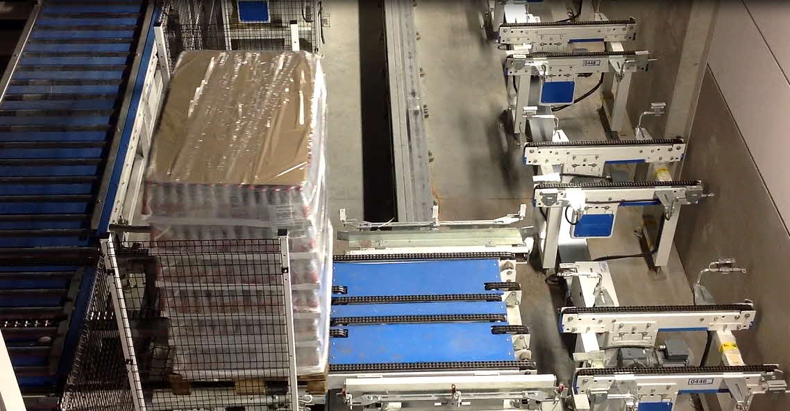 Inverted Monorail Picks Up a Pallet at ASRS Output Station